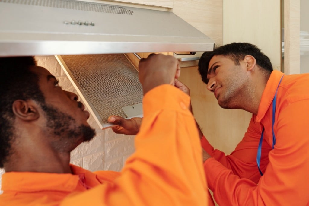 men repairing kitchen hood 2021 09 03 11 14 21 utc